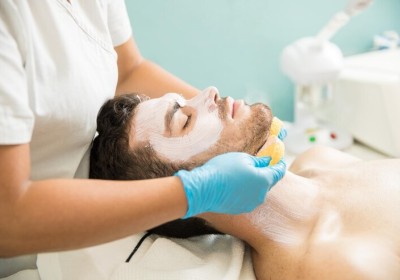 Man receiving facial treatment at a salon