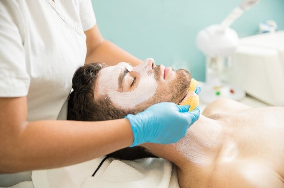 Man receiving facial treatment at a salon