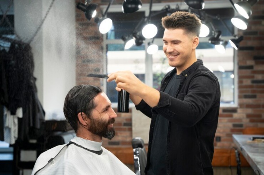 Barber giving a haircut to a satisfied customer in a stylish grooming salon