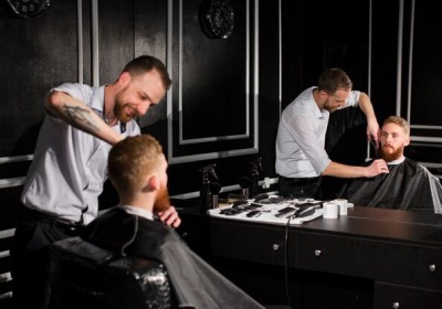 Skilled barber creating a modern hairstyle in the best barbershop in Dubai