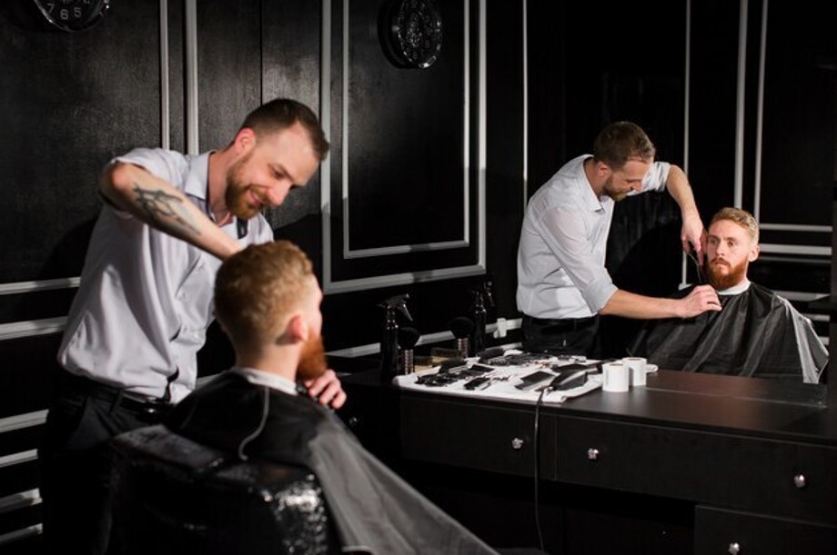 Skilled barber creating a modern hairstyle in the best barbershop in Dubai