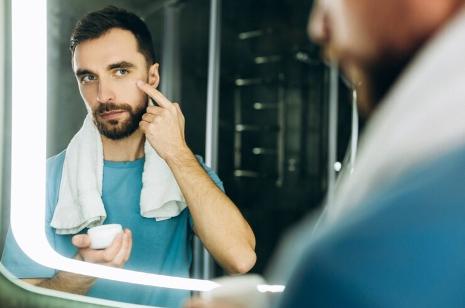 Well-groomed man looking confident with clear skin, styled hair, and trimmed beard