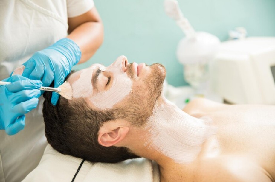 Male receiving a facial treatment at a spa