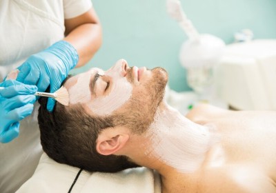 Male receiving a facial treatment at a spa
